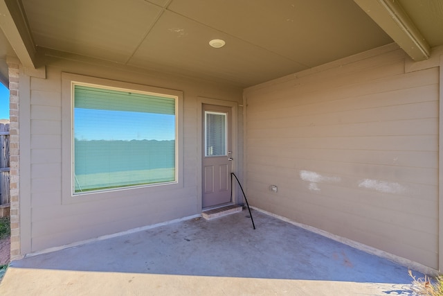 entrance to property featuring a patio area