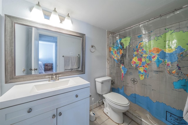 bathroom with curtained shower, toilet, tile patterned flooring, and vanity