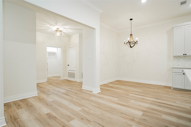 interior space featuring a notable chandelier, light hardwood / wood-style flooring, and ornamental molding