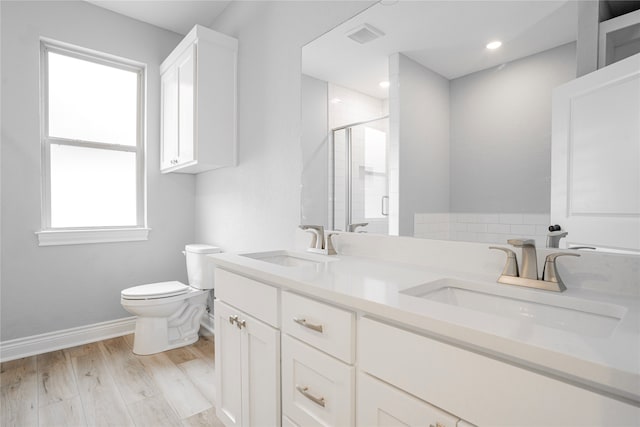 bathroom with toilet, wood-type flooring, walk in shower, and vanity