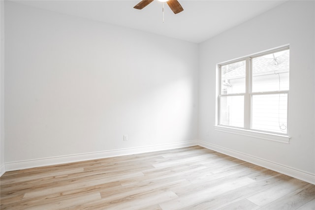 spare room with light hardwood / wood-style floors, ceiling fan, and plenty of natural light