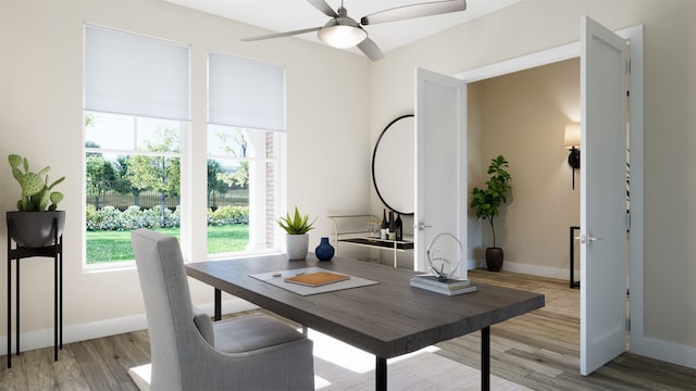 home office with ceiling fan and light hardwood / wood-style floors