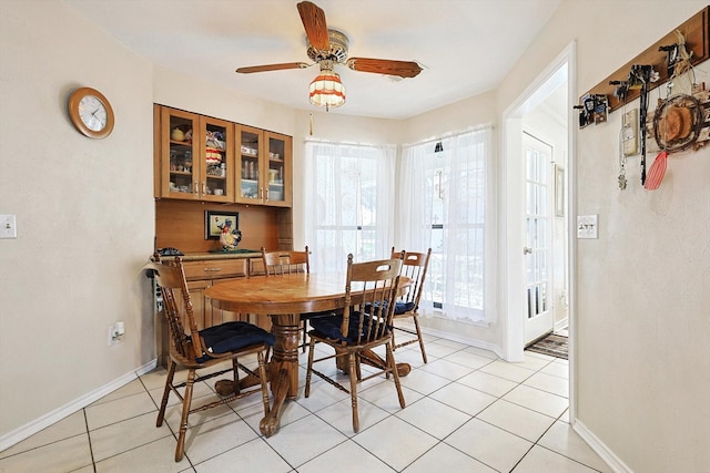 dining area with light tile patterned flooring, ceiling fan, and a healthy amount of sunlight