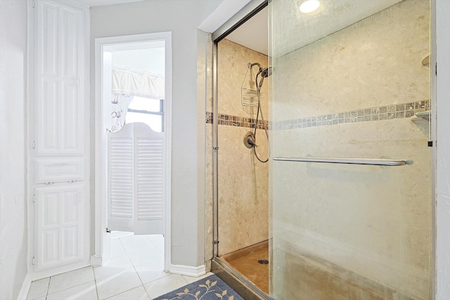 bathroom with tile patterned floors and a shower with shower door