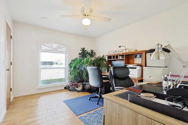 home office featuring ceiling fan and light hardwood / wood-style flooring