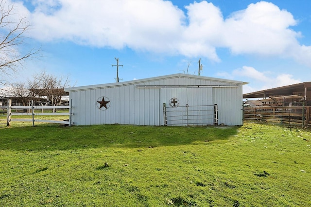 view of outbuilding featuring a yard