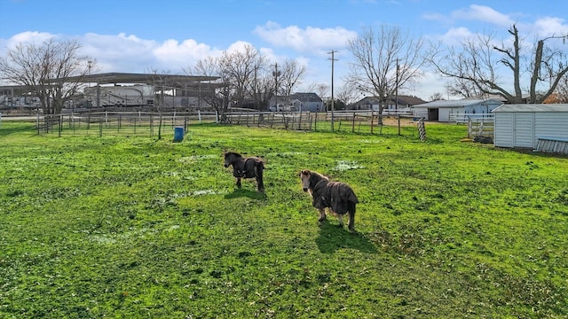 view of yard featuring an outbuilding and a rural view