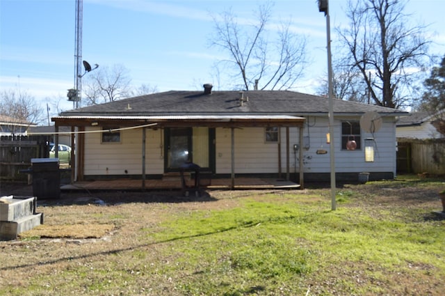 rear view of house featuring a yard