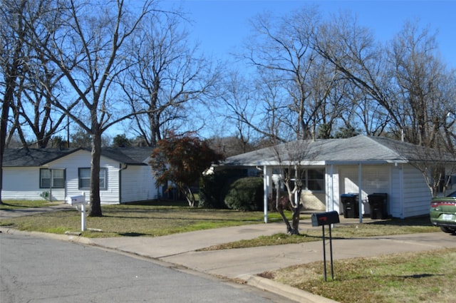 ranch-style home with a front lawn and a carport