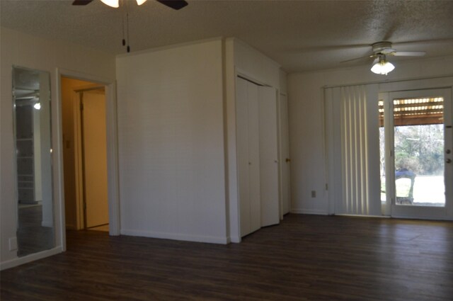 unfurnished room with dark hardwood / wood-style floors, ceiling fan, and a textured ceiling