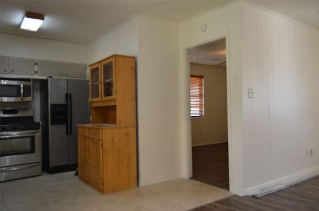 kitchen with appliances with stainless steel finishes and wooden walls