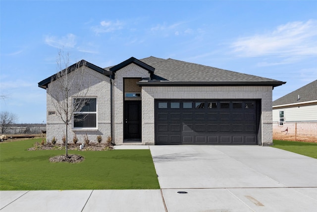 view of front facade featuring a garage and a front lawn