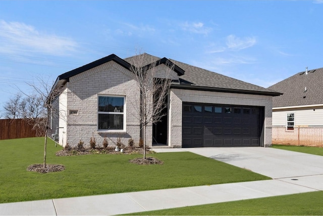 view of front of house featuring a garage and a front lawn