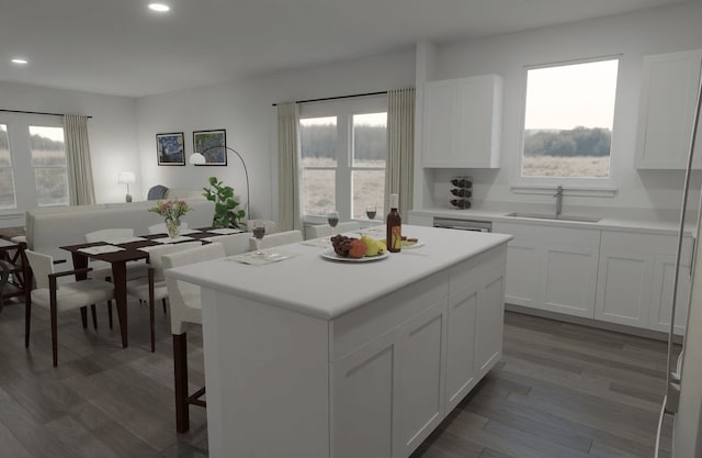 kitchen with dark wood-type flooring, a center island, sink, and white cabinets