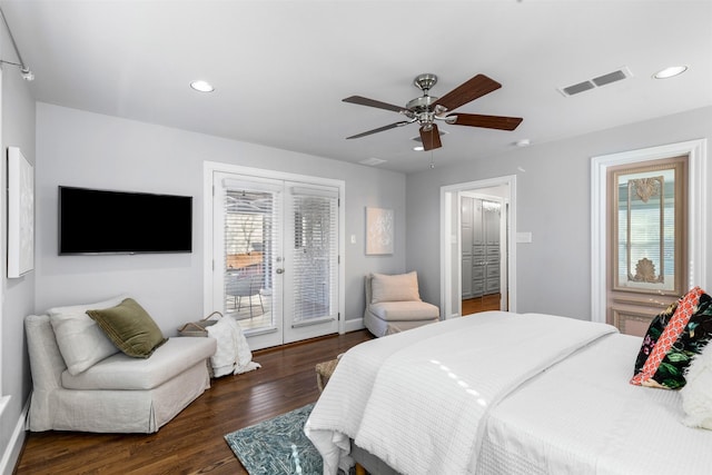 bedroom with dark hardwood / wood-style flooring, ceiling fan, access to exterior, and multiple windows