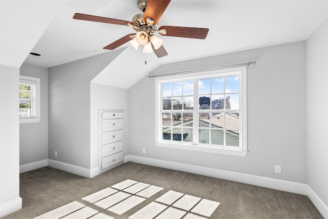 additional living space with carpet flooring, ceiling fan, and vaulted ceiling