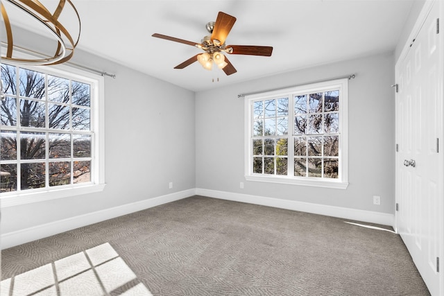 empty room with ceiling fan and carpet flooring