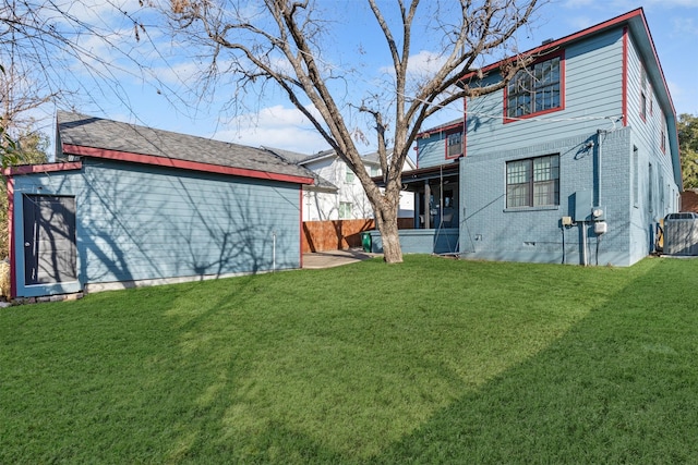 rear view of property with a yard