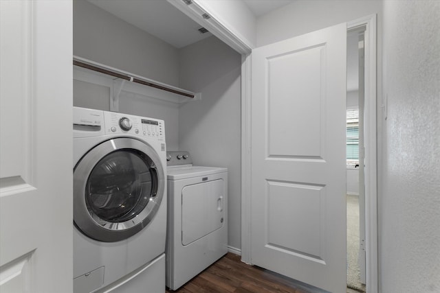 laundry area featuring dark wood-type flooring and washer and dryer