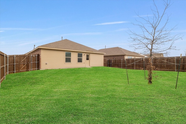 rear view of house with a lawn