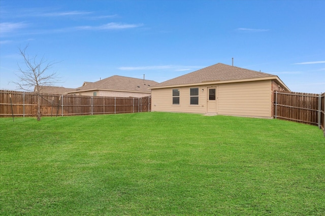 back of house with a yard