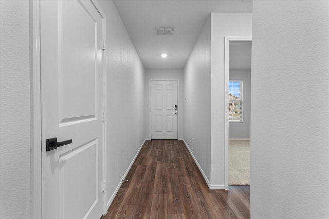 corridor featuring dark wood-type flooring