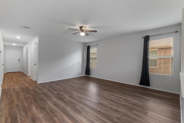 unfurnished room featuring ceiling fan and dark hardwood / wood-style floors