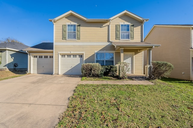 view of front of home with a front yard and a garage