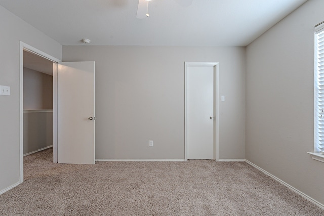 empty room with ceiling fan and carpet floors