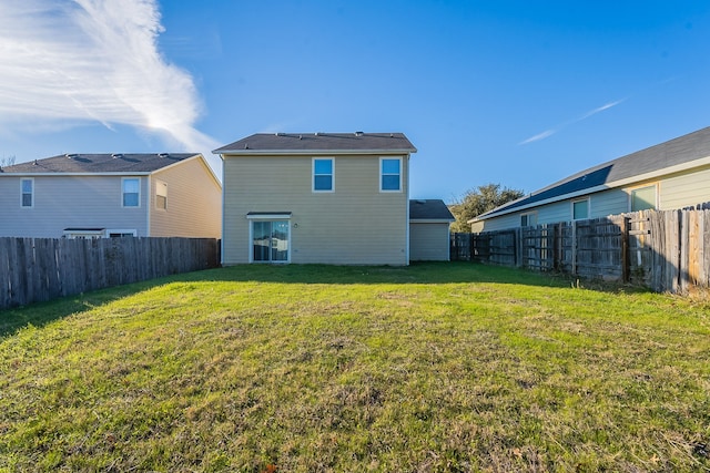 back of house featuring a yard