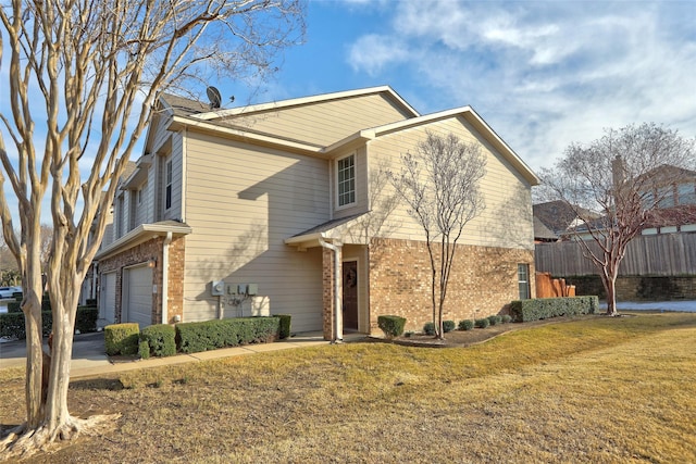 view of front of house featuring a garage and a front lawn