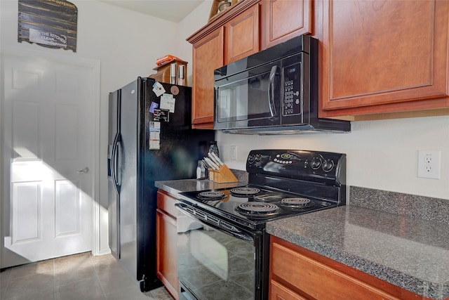 kitchen with black appliances and light tile patterned floors