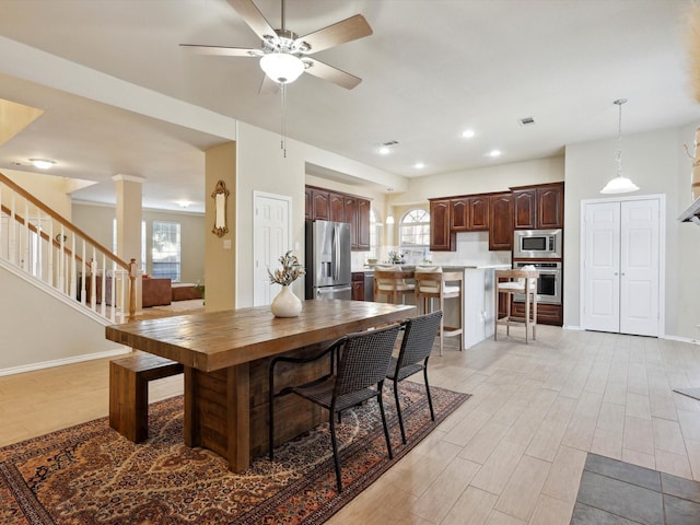 dining space with ceiling fan and plenty of natural light