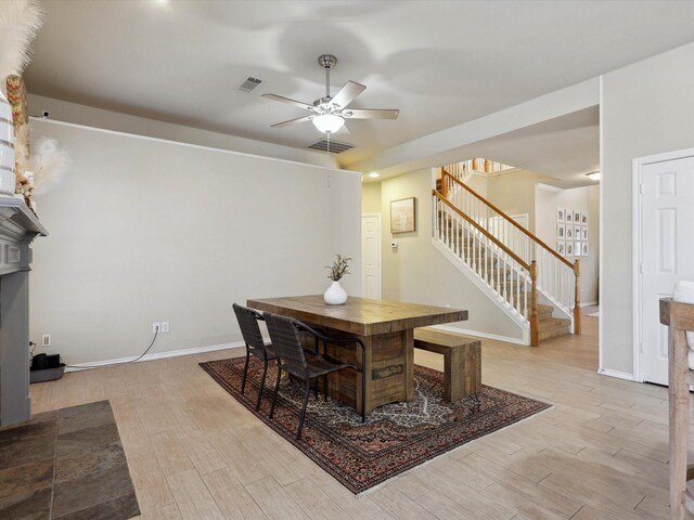 kitchen featuring appliances with stainless steel finishes, light wood-type flooring, tasteful backsplash, decorative light fixtures, and a kitchen island