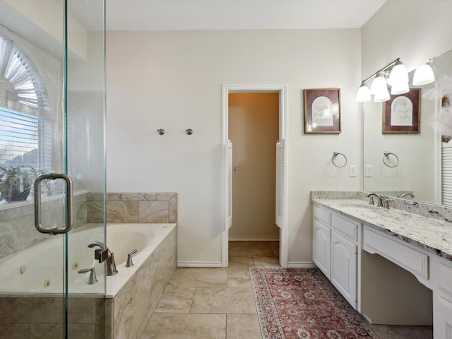 bathroom featuring tiled bath and vanity