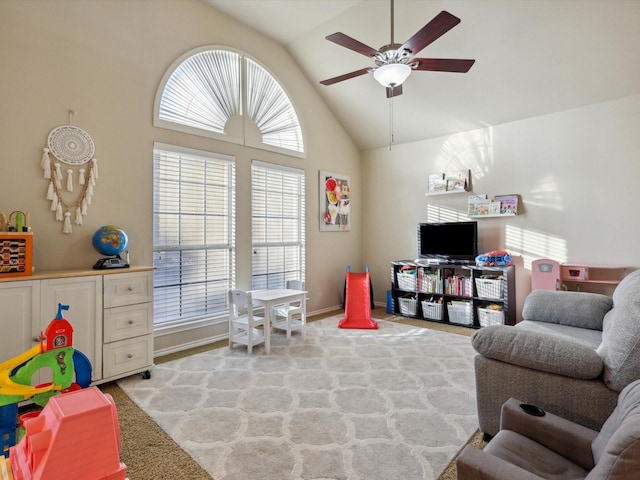 rec room featuring a wealth of natural light, ceiling fan, light carpet, and lofted ceiling