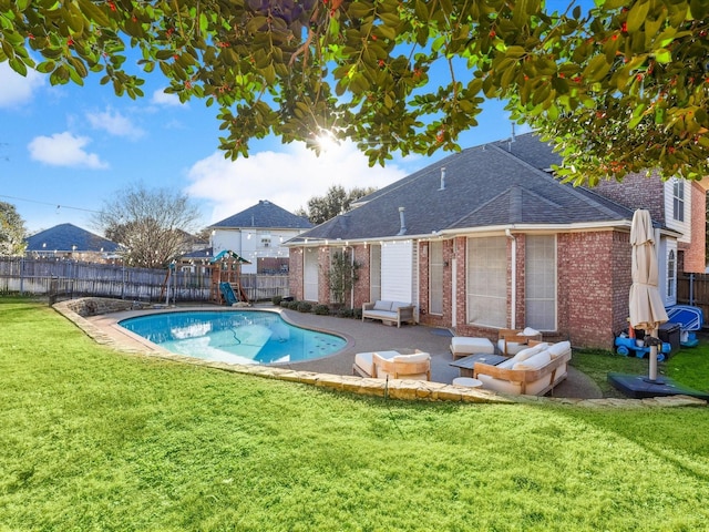 view of swimming pool featuring a lawn and a patio area