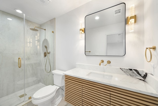 bathroom featuring vanity, toilet, and an enclosed shower