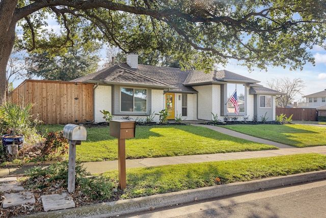 ranch-style home with a front lawn