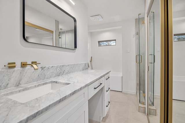 bathroom featuring tile patterned flooring, vanity, and an enclosed shower