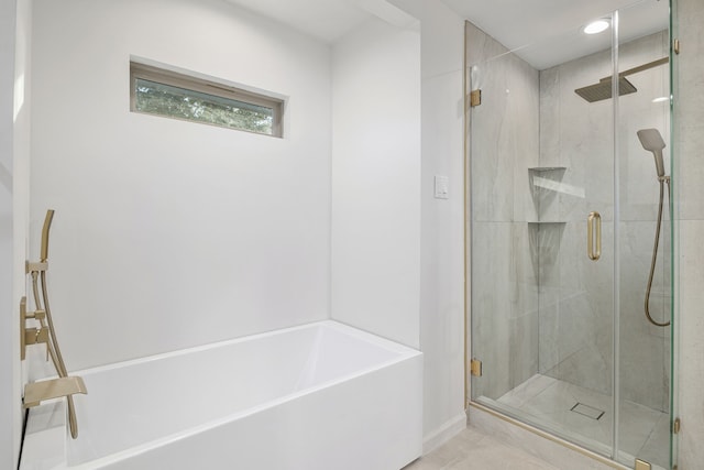 bathroom featuring shower with separate bathtub