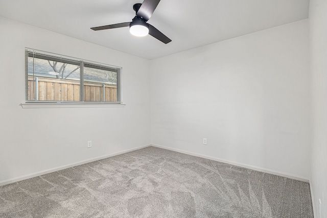 carpeted spare room with ceiling fan