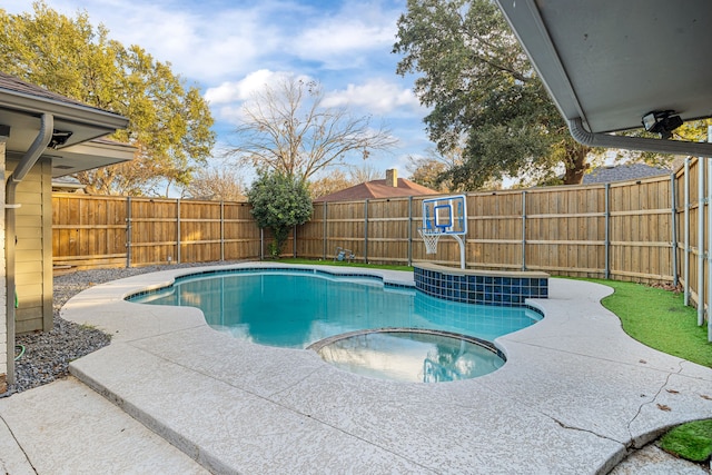 view of swimming pool with a patio area and an in ground hot tub