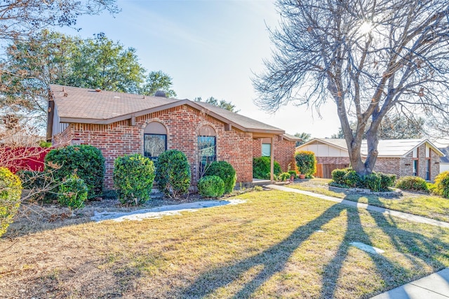 ranch-style home featuring a front yard