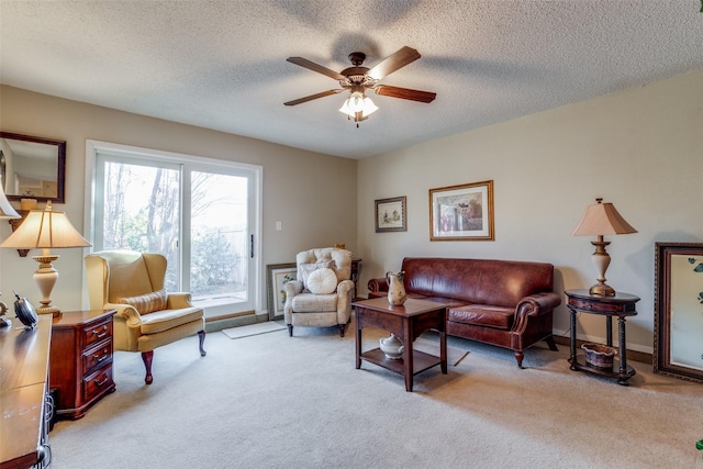 carpeted living room featuring a textured ceiling and ceiling fan