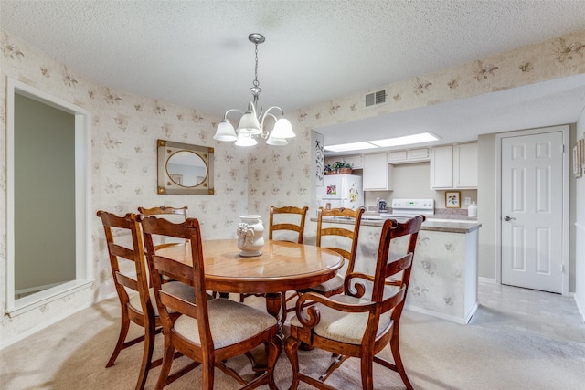 dining space featuring a textured ceiling, a notable chandelier, and light carpet