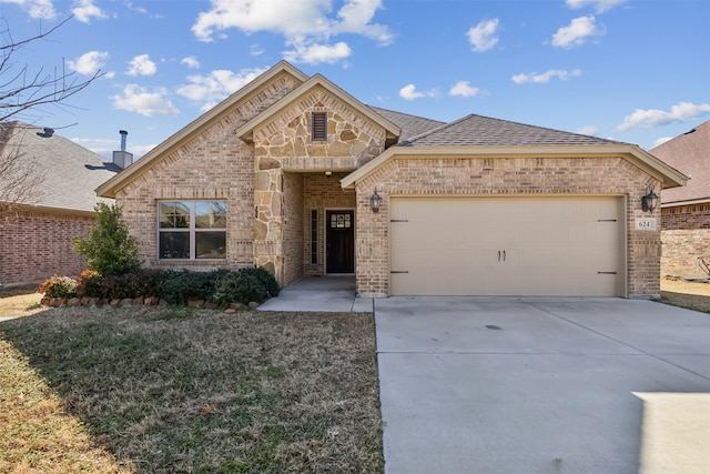 french country inspired facade featuring stone siding, an attached garage, brick siding, and driveway