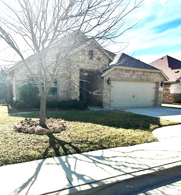 view of front of house with a front yard and a garage