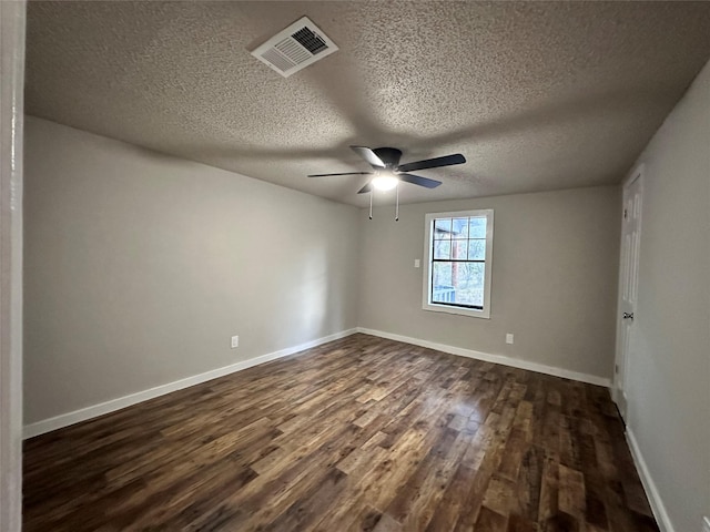 spare room featuring a textured ceiling, ceiling fan, and dark wood-type flooring