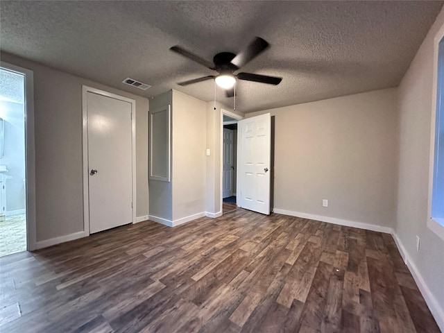 unfurnished bedroom with a textured ceiling, ceiling fan, and dark hardwood / wood-style floors